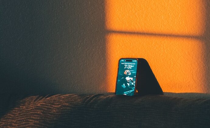 Bild av en ensam telefon på en säng.
